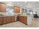 Well-lit kitchen with stainless steel appliances, hard wood cabinets and custom backsplash with view to living area at 185 Rocko Dr., Myrtle Beach, SC 29579
