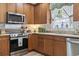 Cozy kitchen with stainless steel appliances, light backsplash and hardwood cabinets and floors at 185 Rocko Dr., Myrtle Beach, SC 29579