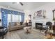 Cozy living room with fireplace, comfortable seating, and bright window with patterned drapes at 185 Rocko Dr., Myrtle Beach, SC 29579