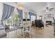 Open-concept living room featuring a fireplace, hardwood floors, and a dining area with backyard access at 185 Rocko Dr., Myrtle Beach, SC 29579