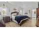 Bright main bedroom features a tray ceiling, wood floors, and an ensuite bathroom with a neutral palette at 185 Rocko Dr., Myrtle Beach, SC 29579