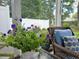 Inviting screened porch, complete with wicker furniture and cushions, overlooking a lush backyard at 185 Rocko Dr., Myrtle Beach, SC 29579