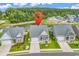 An aerial view of the home nestled between other beautiful houses and overlooking a tranquil pond at 1898 Moonseed Dr., Longs, SC 29568
