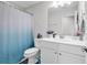 This bathroom features a single sink vanity with decorative plants and a shower with a blue decorative curtain at 1898 Moonseed Dr., Longs, SC 29568
