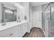Modern bathroom with double sink vanity, glass-enclosed shower, and stylish tile work at 1898 Moonseed Dr., Longs, SC 29568