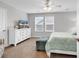 Bright bedroom with a ceiling fan, neutral walls, large window, and a comfortable bed at 1898 Moonseed Dr., Longs, SC 29568