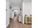 Bright hallway with hardwood floors, neutral paint, and decorative furniture for a welcoming entrance at 1898 Moonseed Dr., Longs, SC 29568