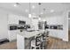 Elegant kitchen with white cabinets, granite counters, and a spacious island for meal preparation and casual dining at 1898 Moonseed Dr., Longs, SC 29568