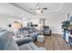 Spacious living room with wood floors, a cozy seating area, and access to the kitchen for seamless entertaining at 1898 Moonseed Dr., Longs, SC 29568