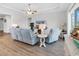 Bright living room with wood-look flooring, comfortable seating, and a view of the backyard at 1898 Moonseed Dr., Longs, SC 29568