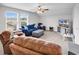 This living room features a ceiling fan, 2 windows, and comfortable seating with a TV on a console at 1898 Moonseed Dr., Longs, SC 29568