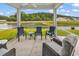 A screened porch featuring outdoor seating overlooking the serene lake at 1898 Moonseed Dr., Longs, SC 29568