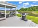 This property's screened in porch features outdoor seating and a grill overlooking a peaceful pond at 1898 Moonseed Dr., Longs, SC 29568