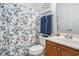 Cozy bathroom featuring a floral shower curtain, wood vanity, and ample lighting at 2005 Silvercrest Dr. # 32F, Myrtle Beach, SC 29579