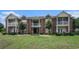 Exterior of the building with a walkout porch and manicured lawn at 2005 Silvercrest Dr. # 32F, Myrtle Beach, SC 29579