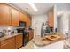 Well-lit kitchen with wooden cabinets, countertops, and essential appliances at 2005 Silvercrest Dr. # 32F, Myrtle Beach, SC 29579