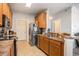 Functional kitchen with wooden cabinets, practical appliances, and a tiled floor at 2005 Silvercrest Dr. # 32F, Myrtle Beach, SC 29579