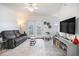 Bright living room featuring a ceiling fan, exterior door, and modern furnishings at 2005 Silvercrest Dr. # 32F, Myrtle Beach, SC 29579