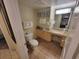 Well-lit bathroom featuring granite countertops, a sink, a toilet, and soft towels at 201 S Ocean Blvd. # 205, Myrtle Beach, SC 29577