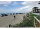 Scenic beach view with lounge chairs and umbrellas lining the shore at 201 S Ocean Blvd. # 205, Myrtle Beach, SC 29577