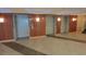 Elevator bank featuring three elevators with wooden panels and tile flooring at 201 S Ocean Blvd. # 205, Myrtle Beach, SC 29577