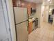 Kitchen featuring stainless steel refrigerator, microwave, and oven, and wood cabinets at 201 S Ocean Blvd. # 205, Myrtle Beach, SC 29577