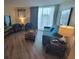 Cozy living room with balcony access, perfect for relaxation and entertaining at 201 S Ocean Blvd. # 205, Myrtle Beach, SC 29577