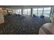 Lounge area with beach views featuring chairs, tables, and decorative patterned flooring at 201 S Ocean Blvd. # 205, Myrtle Beach, SC 29577