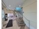Hallway featuring stairs and stainless steel railings, with tile flooring and neutral wall colors at 201 S Ocean Blvd. # 205, Myrtle Beach, SC 29577