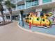 Playful splash pad with a submarine structure and palm trees, with a beach in the background at 201 S Ocean Blvd. # 205, Myrtle Beach, SC 29577