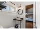 Cozy bathroom with a sink, wooden countertop, round mirror, and access to the bunk room at 204 55Th Ave. N, North Myrtle Beach, SC 29582