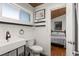 Modern bathroom featuring a toilet, sink, and floating shelves. Connects to another bedroom at 204 55Th Ave. N, North Myrtle Beach, SC 29582
