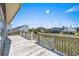 Spacious deck with white railings overlooks the yard and surrounding neighborhood at 204 55Th Ave. N, North Myrtle Beach, SC 29582