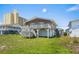 Exterior shot of the beach home with a spacious deck and stairs to the yard at 204 55Th Ave. N, North Myrtle Beach, SC 29582