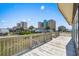 Balcony with views of local buildings, vegetation, and the beautiful blue skies at 204 55Th Ave. N, North Myrtle Beach, SC 29582