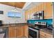 Kitchen with stainless steel appliances, wooden cabinets and a window overlooking outdoor beaches at 204 55Th Ave. N, North Myrtle Beach, SC 29582