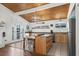 Kitchen with wood ceiling, island with eat in space, appliances and exterior doors for easy indoor/outdoor living at 204 55Th Ave. N, North Myrtle Beach, SC 29582