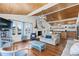 Living room with wood ceilings, blue accents and lots of natural light open to the kitchen area at 204 55Th Ave. N, North Myrtle Beach, SC 29582