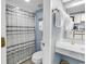 Bathroom with a toilet, sink, shower with striped curtain and mirrored reflection of kitchen at 2300 N Ocean Blvd. # 132, Myrtle Beach, SC 29577