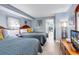 Bedroom with two beds, light wood floors, and light blue walls at 2300 N Ocean Blvd. # 132, Myrtle Beach, SC 29577
