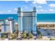 Oceanfront building with an ocean view, palm trees, and parking at 2300 N Ocean Blvd. # 132, Myrtle Beach, SC 29577