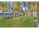 Beachside patio featuring lounge chairs, picnic tables, palm trees and beach access at 2300 N Ocean Blvd. # 132, Myrtle Beach, SC 29577