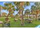 Well-manicured lawn area with picnic tables, chairs and palm trees by the beach at 2300 N Ocean Blvd. # 132, Myrtle Beach, SC 29577