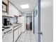 Bright kitchen with white cabinets, tiled floor, and modern appliances is the perfect size at 2300 N Ocean Blvd. # 132, Myrtle Beach, SC 29577