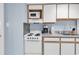 Kitchenette with white appliances and cabinets at 2300 N Ocean Blvd. # 132, Myrtle Beach, SC 29577