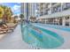 Outdoor pool with surrounding lounge chairs and palm trees, adjacent to a modern building at 2300 N Ocean Blvd. # 132, Myrtle Beach, SC 29577