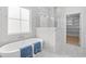 Luxurious bathroom featuring a soaking tub, marble accents, and a large window at 2313 Summersweet Ln., Myrtle Beach, SC 29579