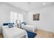 Bright bedroom features two twin beds, modern decor, and hardwood flooring at 2313 Summersweet Ln., Myrtle Beach, SC 29579