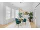 Dining room features a glass table, green chairs, and large windows, perfect for meals and gatherings at 2313 Summersweet Ln., Myrtle Beach, SC 29579