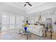 Bright, open living room with comfortable seating, hardwood floors, and large windows with flowing light at 2313 Summersweet Ln., Myrtle Beach, SC 29579